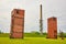 Tiered grassy hill near old abandoned freight elevator buildings and distant watch tower