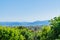 Tiered mountain ranges in distance beyond orchards of northern T