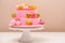 Tiered pink birthday cake for little girl. Happy birthday party. Modern mousse cake. Birthday cake covered with pink chocolate