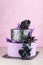 Tiered wedding cake with black fake flowers