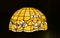 Tiffany lamp in yellow color illuminated