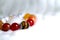 Tiger eye and various quartz lucky stone bracelet in red and white tone on white wool texture background