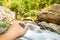 Tiger moth on man`s hand nearby waterfall