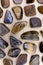 Tiger`s Eye rare jewel on light wood texture. Sparse mineral pebbles background