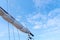 Tigging and masts of an old sailing ship against the blue sky with clouds. Travel adventure and travel concept, copy space