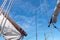 Tigging and masts of an old sailing ship against the blue sky with clouds. Travel adventure and travel concept, copy space