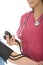 Tight Crop of a Professional Young Female Doctor Taking The Blood Pressure Of A Patient