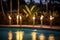 tiki torches around a swimming pool