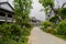 Tile-roofed buildings along flagstone street in cloudy spring