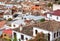 Tile roofs of houses on cityscape of Granada. Landscape of historical town of Andalusia, Spain