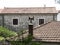 Tile roofs of white stone houses side view