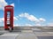 Tiled background with british phone box, tabby cat and blue sky