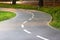 Tiled bike path. Curving sidewalk. Winding road