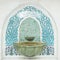 Tiled ornament drinking water fountains on forecourt of islamic mosque