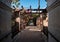 Tiled pathway through pergola to entrance gate