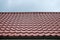 Tiled patterned red roof against a blue sky