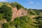 Tiled rocky hills with a dirt road at the foot of the blue sky