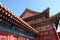 Tiled roof and facade decorated with a Chinese pattern. Palace in The Forbidden City, Beijing