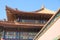 Tiled roof and facade decorated with a Chinese pattern. Palace in The Forbidden City, Beijing