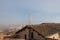 Tiled roofs of Siena and Torre del Mangia in fog on background. Tuscany. Italy.