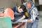 Tiler and apprentice using thermal grinder