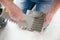 Tiler laying the ceramic tile on the floor. Professional worker makes renovation. Construction. Hands of the tiler