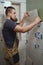 Tiler laying installing ceramic tiles on the wall in the bathroom