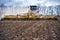 Tillage in the field with a tractor with a trailed machine