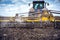 Tillage in the field with a tractor with a trailed machine