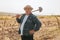 Tilling the Soil Senior Farmer with Shovel in Hand, looking at camera