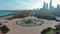 tilt aerial footage of a beautiful autumn landscape at Grant Park with Buckingham Fountain, autumn trees and green grass