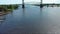 tilt aerial footage of the flowing waters of Cape Fear River and Cape Fear Memorial Bridge with cars and trucks driving