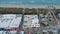 tilt aerial footage off the Carolina Beach Boardwalk with a Ferris wheel, colorful amusement rides, people walking, a sandy beach