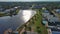 tilt aerial footage over Carolina Lake with homes along the shore, lush green trees and grass, boat docks and blue sky with clouds