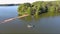 tilt aerial footage of two men in a small boat fishing in the rippling green waters of Lake Acworth