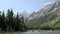 Tilt down shot of the grand tetons and leigh lake near jackson hole, wyoming