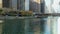 tilt footage of a beautiful autumn landscape along the Chicago River with a boat sailing on the water, skyscrapers