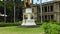 tilt footage of the King Kamehameha statue in front of Aliiolani Hale with lush palm trees, grass and plants in Honolulu Hawaii