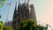 Tilt of front and old facade of sagrada familia cathedral in barcelona, spain at sunset on a sunny summer sunset, view from the