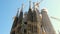 Tilt of front and old facade sagrada familia church in barcelona at sunset on a sunny summer sunset, view from the ground with