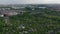 Tilt and pan footage of greenery in large city. Island of trees and vegetation among blocks of residential buildings