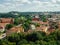 Tilt and shift view of Latvia houses and their sunny roofs among green trees