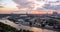 Tilt and shift view of sunset panorama of Moscow with pink clouds, traveling boats and river reflections