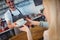 Tilt shot of barista serving coffee to woman at cafe