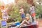 Tilt shot of cheerful couples enjoying with squirt guns on pier during summer