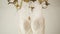 Tilt Shot of a Cream Wedding Dress Hanging on a Gold Vintage Chandelier