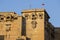 Tilt shot of Jaisalmer Fort sandstone wall with its elaborate sculpted columns, windows and balconies. India