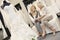 Tilt shot of mother and daughter sitting with footwear in bridal store