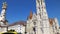 Tilt shot up the main spire of Matthias Church, Fisherman`s Bastion, Budapest, Hungary on a bright sunny day