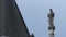 Tilt from a spire to a statue on the Royal Courts